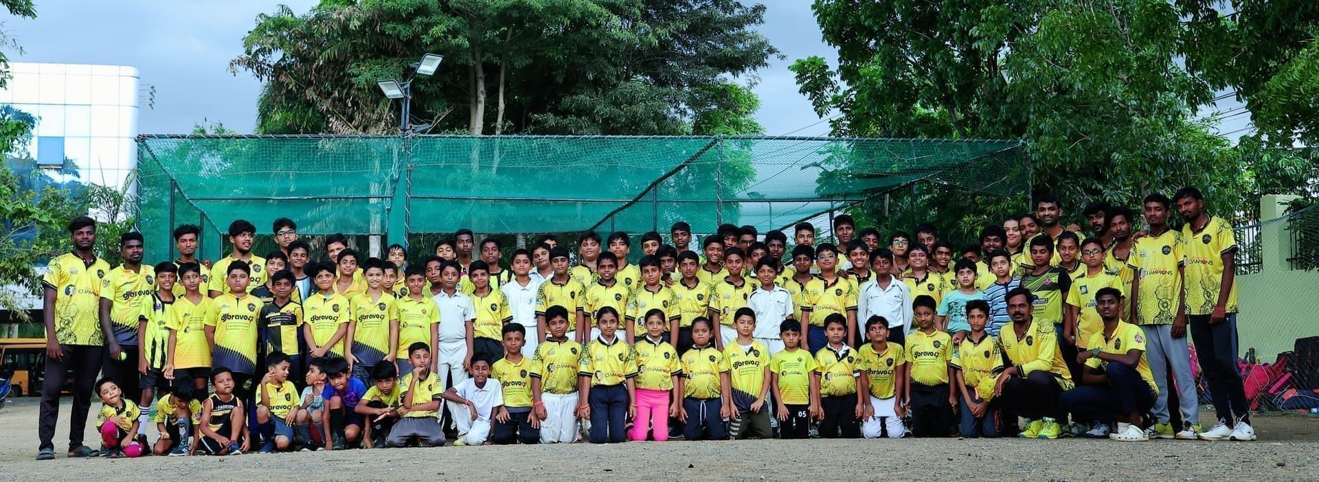 DJ Bravo 47 academy juniors team photo under floodlights