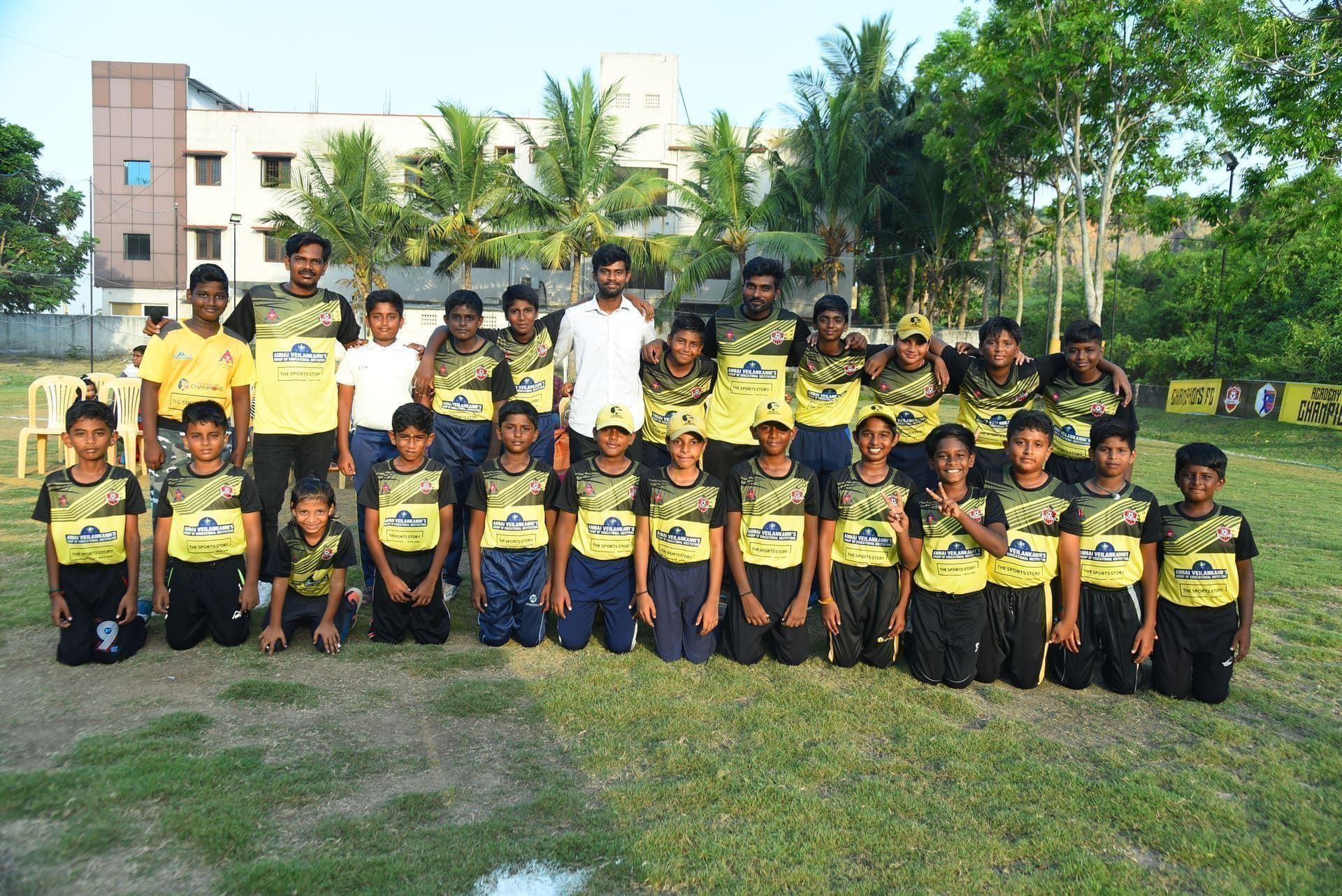 Junior players posing in yellow and black academy kits