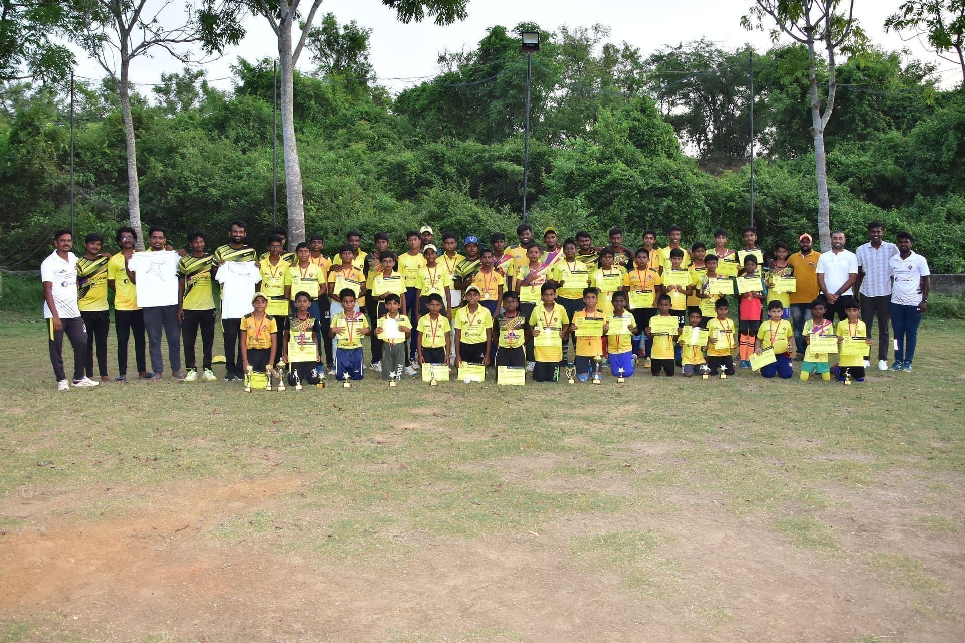 Young players and coaches lining up for an outdoor team photo
