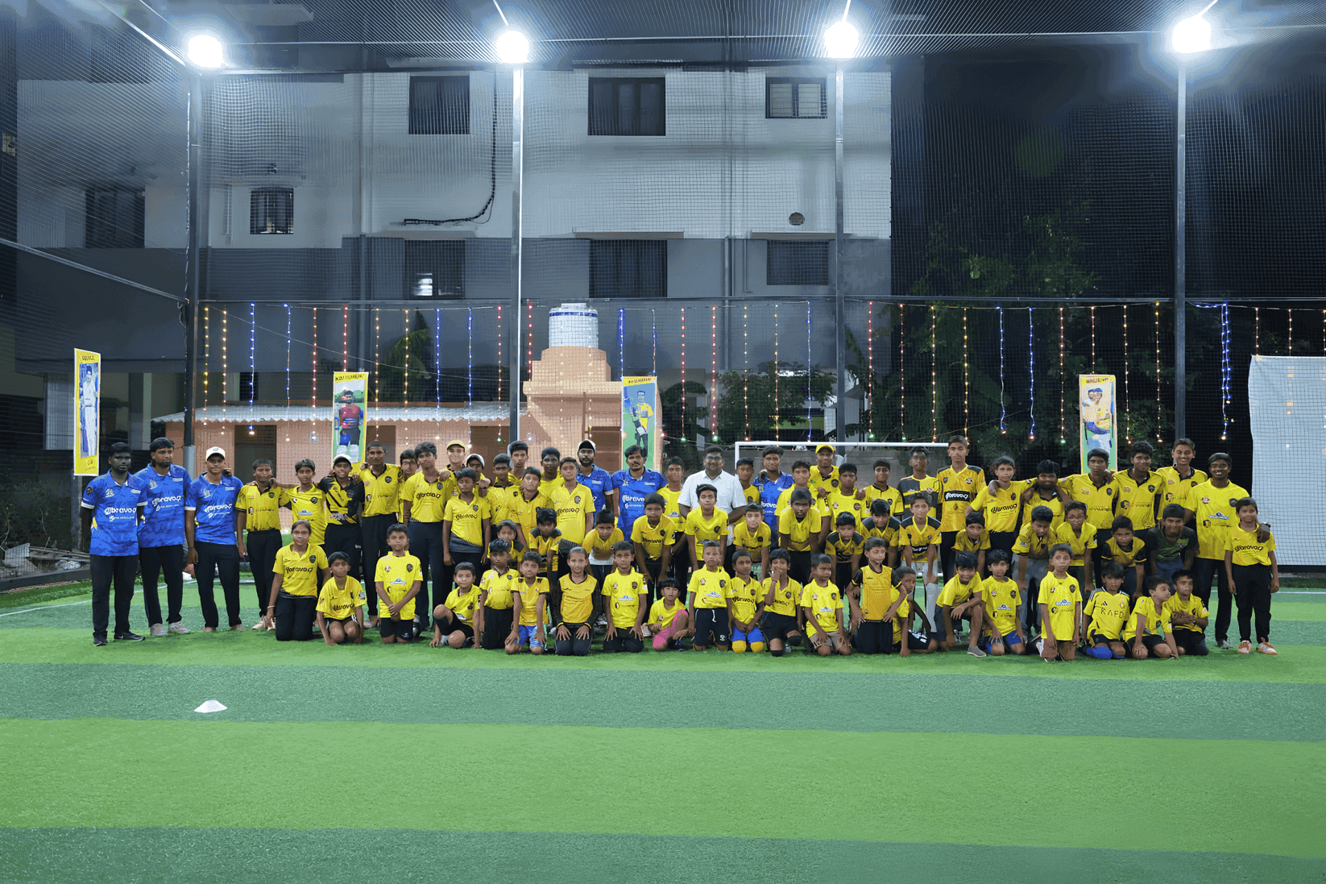 Academy players assembled on a floodlit cricket ground