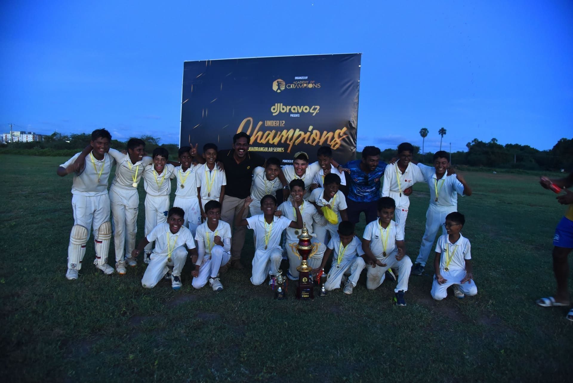 Junior players celebrating together with medals and trophies