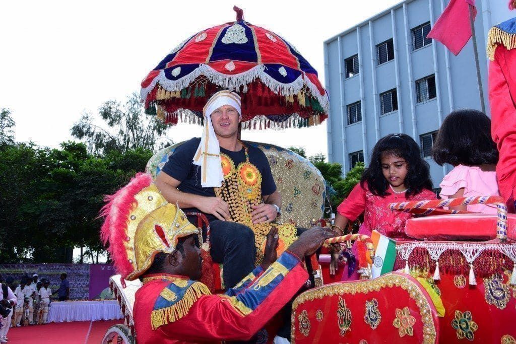 Shane Watson on a ceremonial chariot under a royal umbrella
