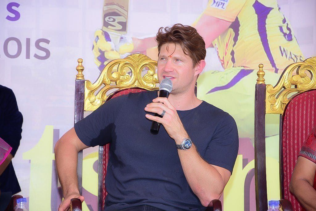 Shane Watson speaking on stage at a keynote address