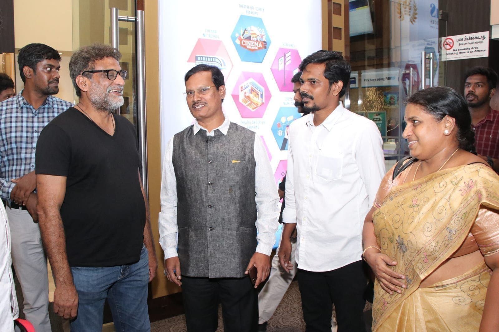 Guests and hosts gathered at an indoor community event