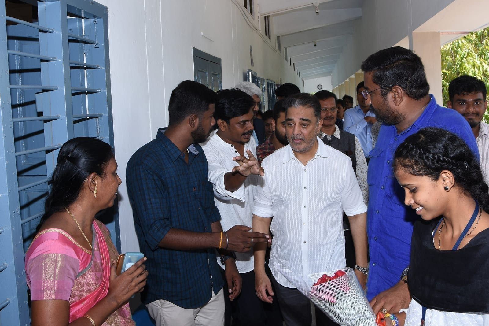 Visitors greeting community members during an indoor visit