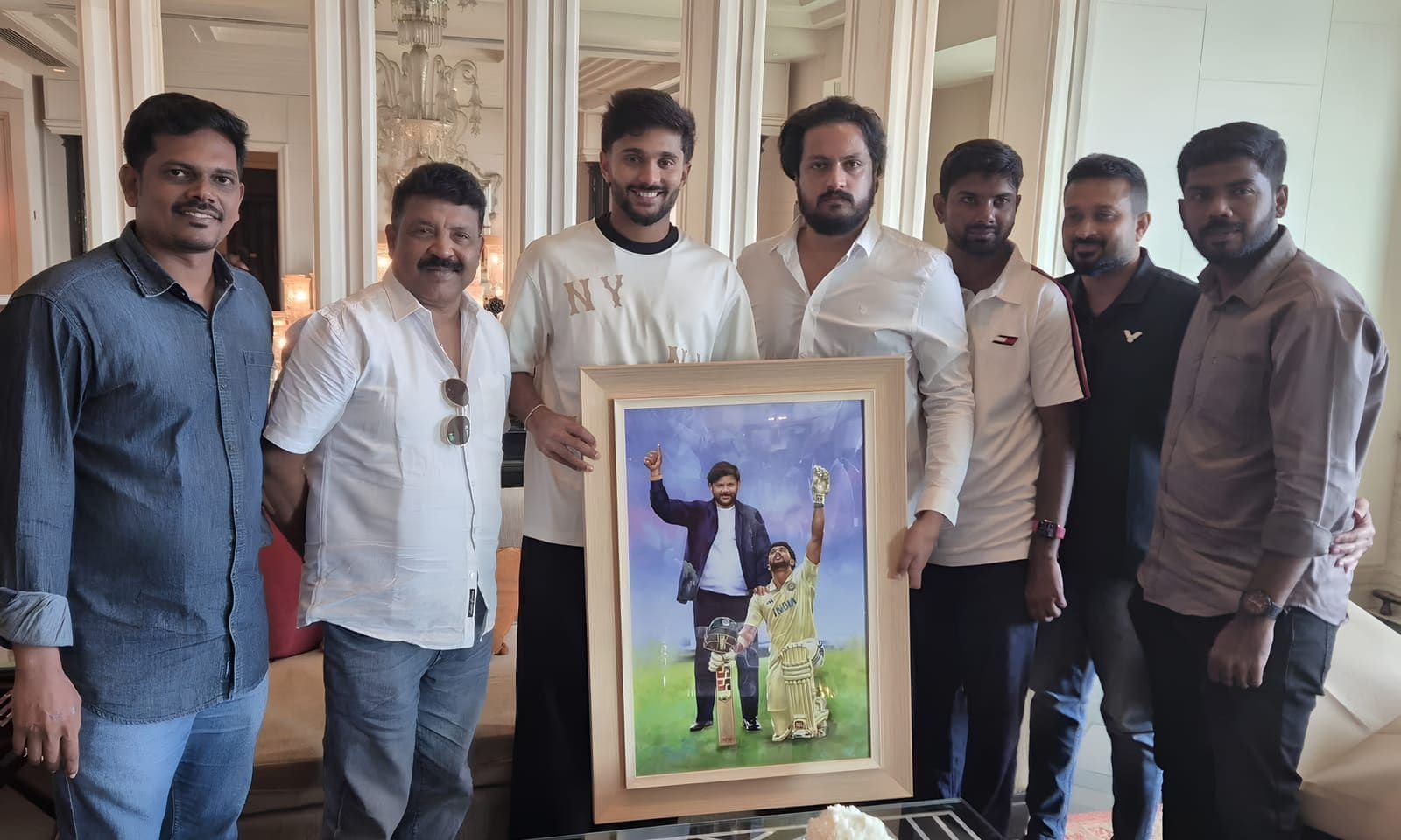 Group of guests holding a framed cricket portrait together