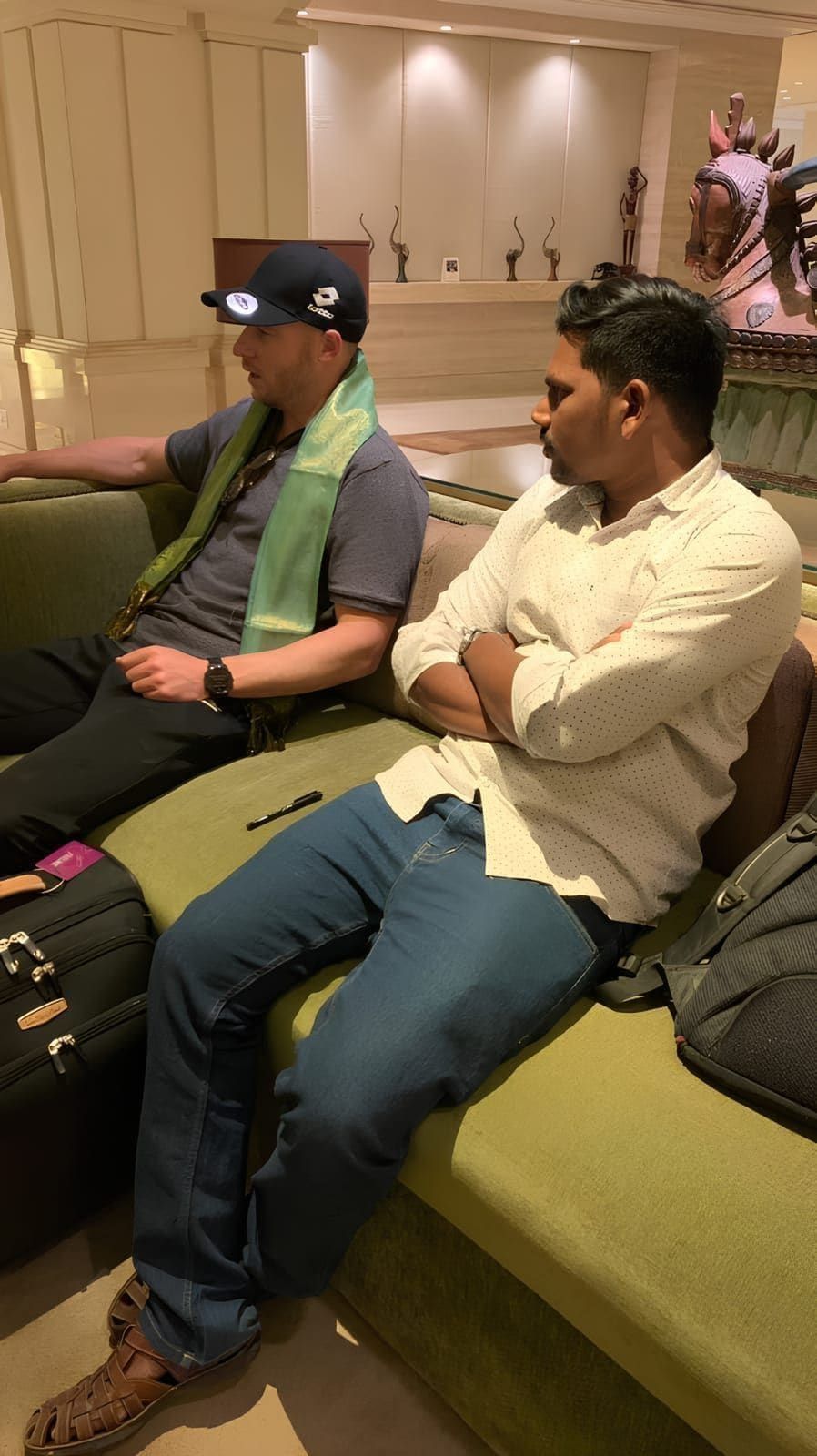 Two guests seated together during an indoor conversation