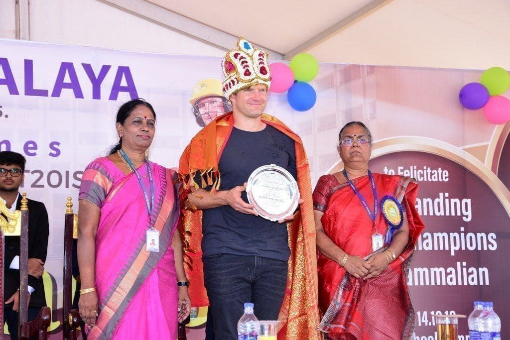 Shane Watson receiving a felicitation crown and plaque
