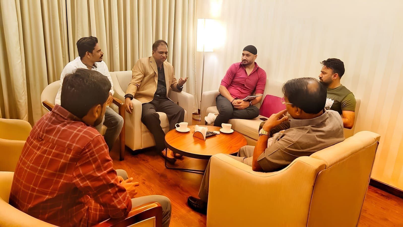 Guests seated around a low table during a lounge discussion