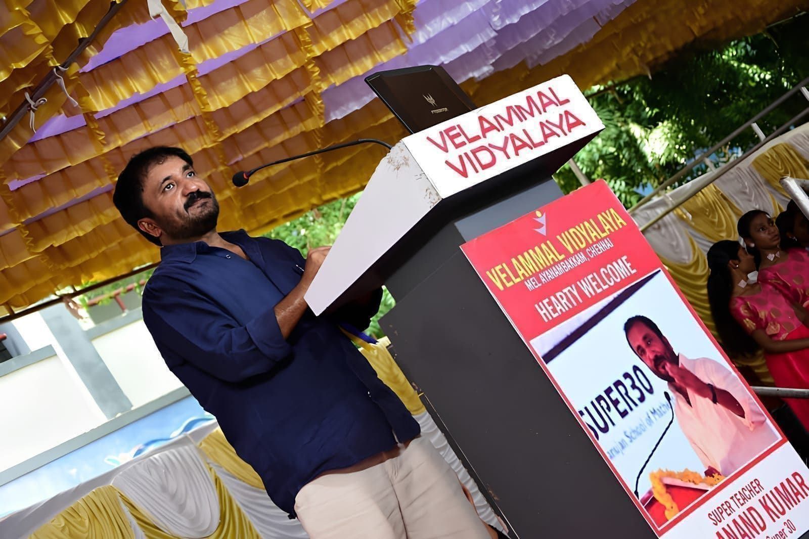 Guest speaking at a Velammal Vidyalaya podium